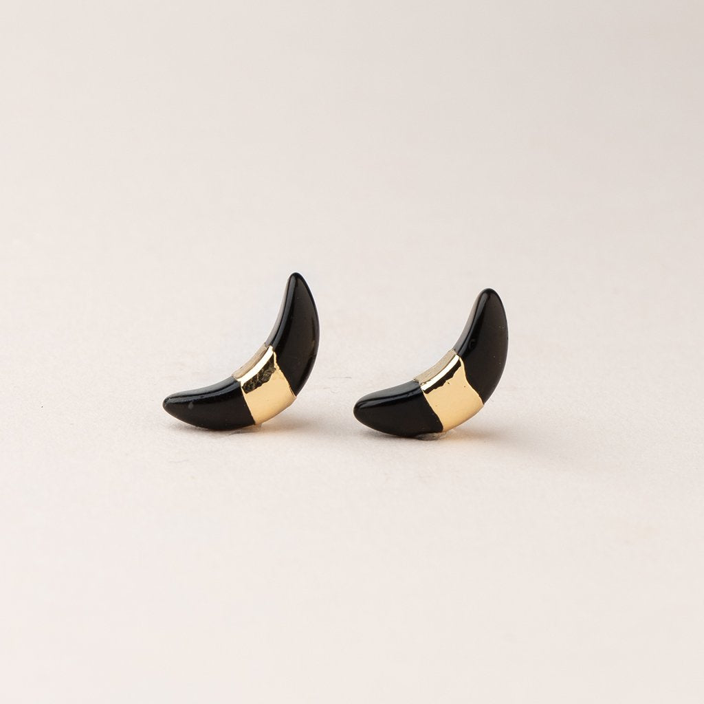 Scout jewelry featuring a pair of stud earrings