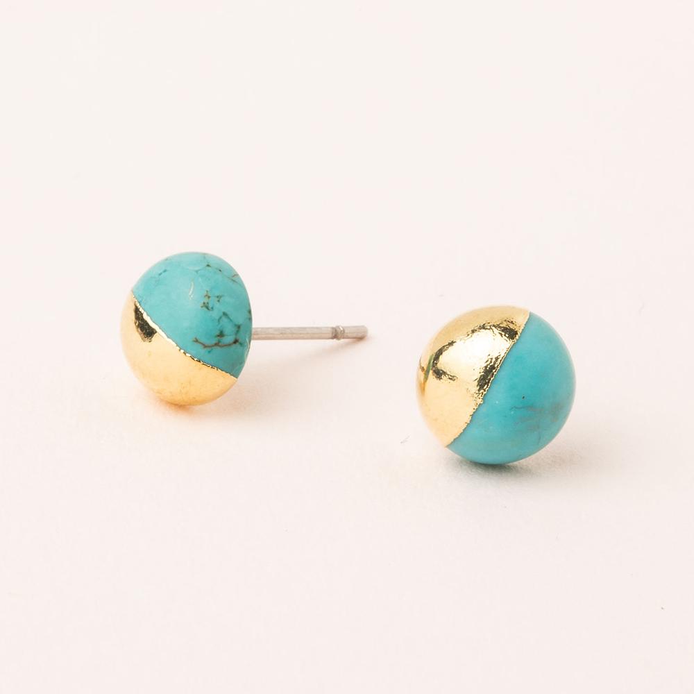 Scout jewelry featuring a pair of stud earrings