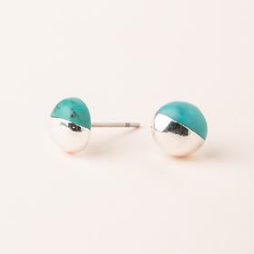 Scout jewelry featuring a pair of stud earrings