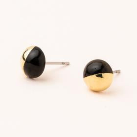 Scout jewelry featuring a pair of stud earrings