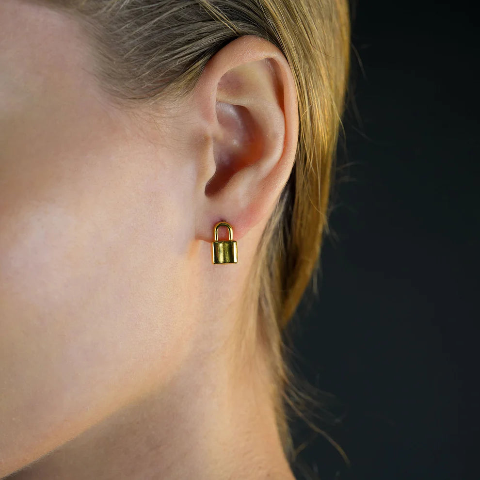 Hackney jewelry featuring a pair of gold lock stud earrings