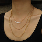 Hackney jewelry featuring 3-layer multi chain gold necklaces with natural pearls. 