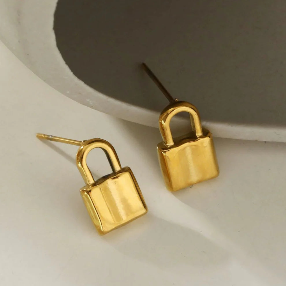 Hackney jewelry featuring a pair of gold lock stud earrings