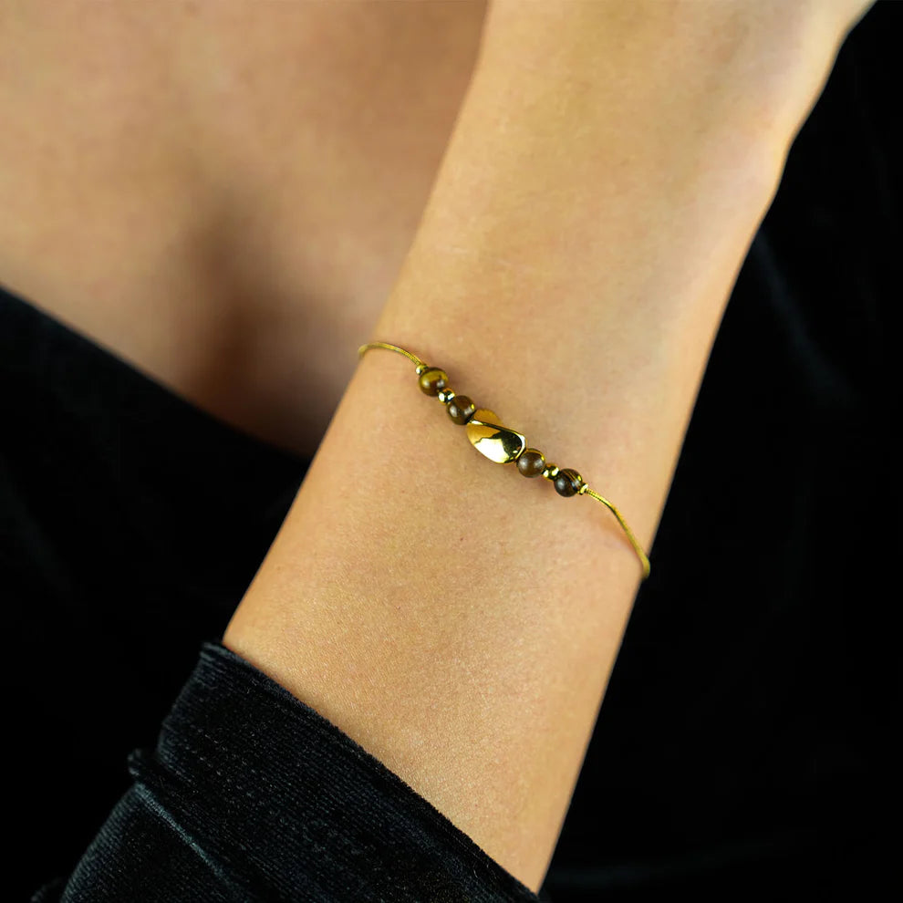 Hackney jewelry featuring a snake skin textured bracelet with gold tiger eye stone charms. 