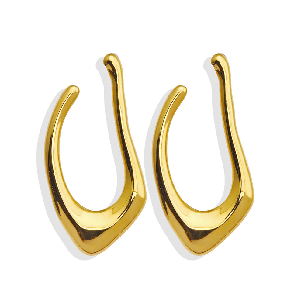 Hackney jewelry featuring a pair of abstract shaped gold hoop earrings.