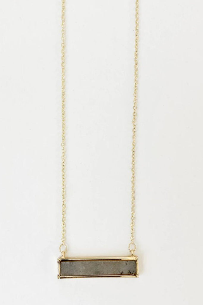 Caracol jewelry featuring a delicate chain necklace with stone pendant