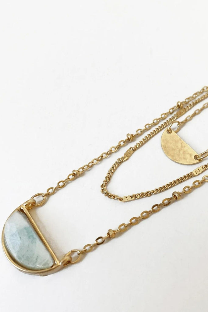 Caracol jewelry featuring a triple chain necklace with labradorite stone pendant