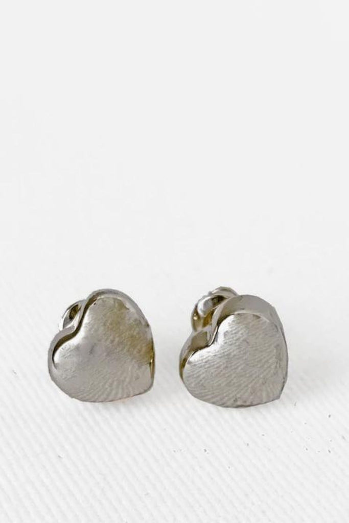 Caracol jewelry featuring a pair of small heart stud earrings