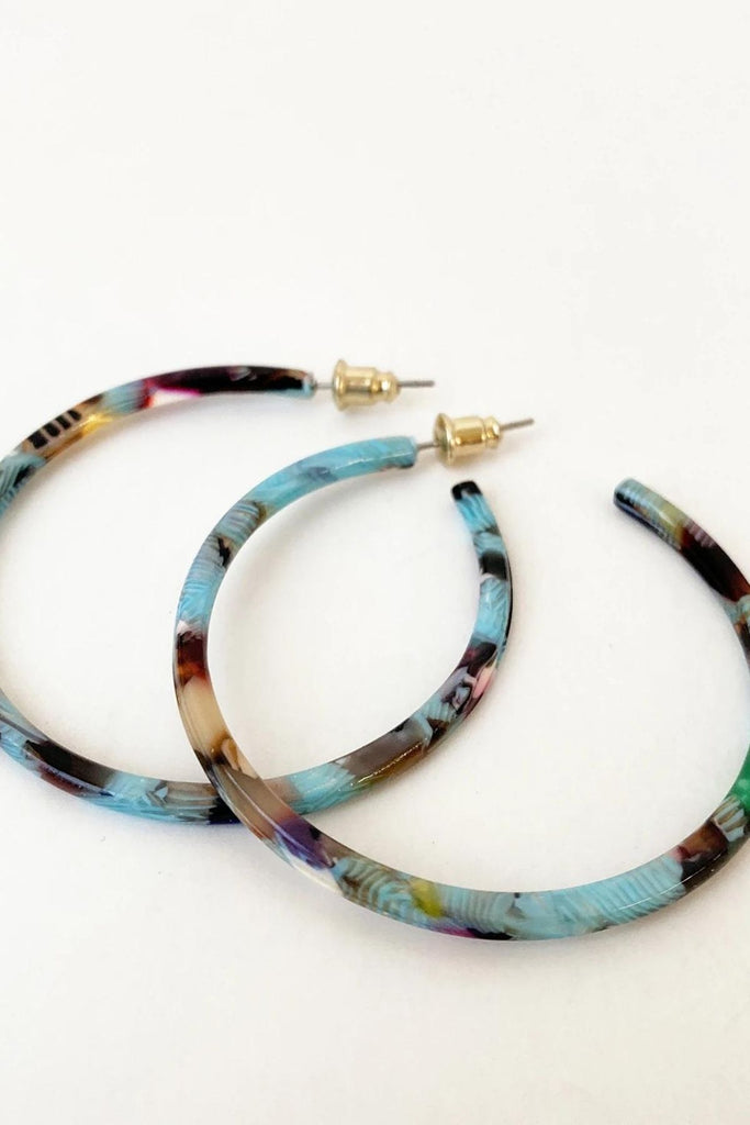 Caracol jewelry featuring a pair of medium sized multi coloured hoop earrings