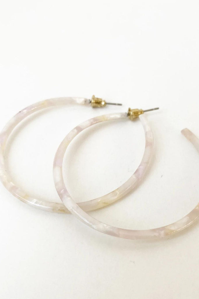 Caracol jewelry featuring a pair of medium sized multi coloured hoop earrings