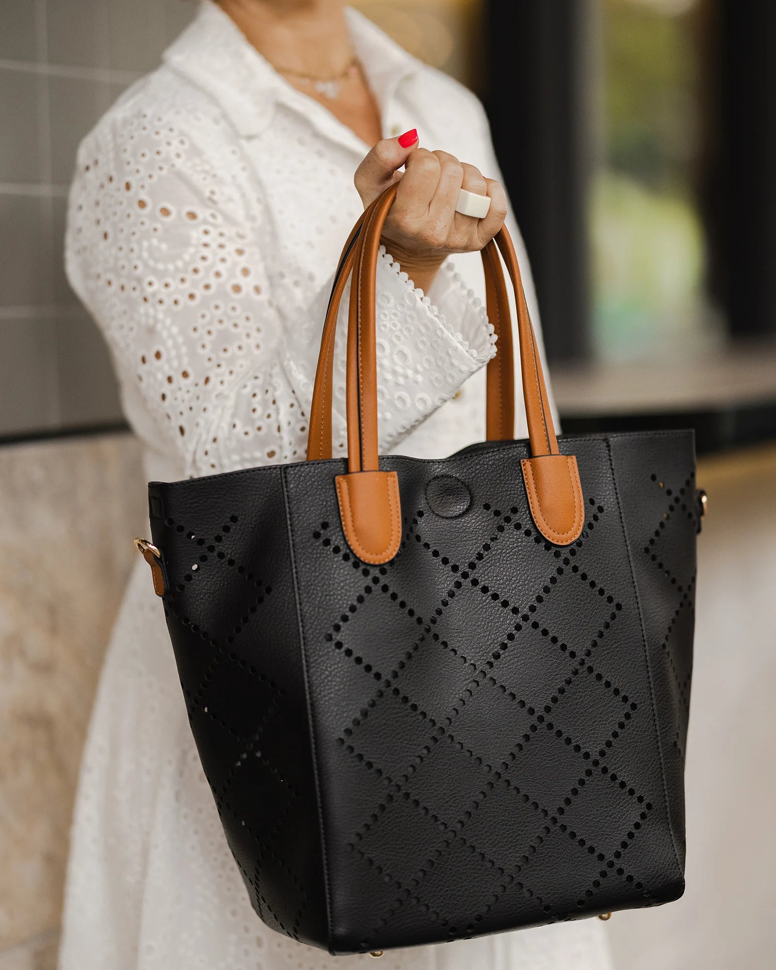 Vegan leather Louenhide bag featuring the 2 in 1 Bermuda purse with laser cut diamond shape design and an extra adjustable strap. 